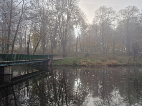 The rising sun in a foggy autumn morning in the Julianowski Park, Lodz, Poland. © bARTkow