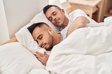 Obraz na płótnie Canvas Two men couple lying on bed sleeping at bedroom