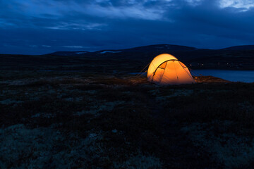 Iluminated tent at night in Norway