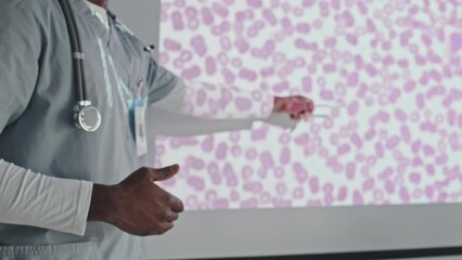 Medium section shot of unrecognizable African American medical worker making presentation at conference or giving lecture to students