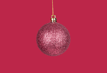 Christmas ball, bauble, sphere ornament of viva magenta color. Monochrome Xmas image with holiday ornament