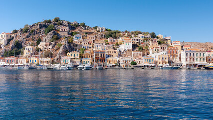 Fototapeta na wymiar Colored houses on the embankment of Symi island, Greece.