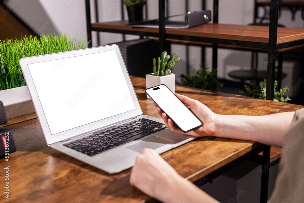 Poster hands with laptop screen mockup and mobile phone, smartphone display mock up at office desk, table
