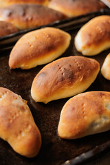 delicious homemade pastries from the oven. women's hands hold a tray with pies, gluten-free dough, yeast-free homemade bread. a family lunch with fragrant pastries or a bakery restaurant. food and