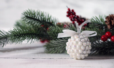 Festive decor for the New Year, white ball of beads, Christmas card.