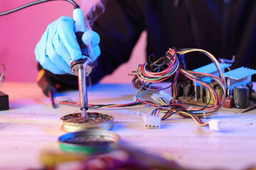 soldering iron in hand and rosin on the table