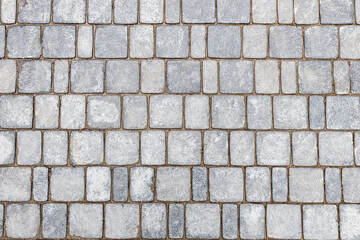 top view of a stone pavement made of gray rectangular bricks