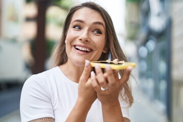 Young caucasian woman smiling confident talking on the smartphone at street