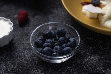 morning breakfast, juicy berries and fruits in a plate, orange, blueberry, raspberry, sea buckthorn and others