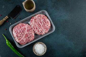 Raw minced meat and ingredients for home made grill burgers. Semifinished food. American cuisine....