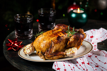 Roasted Turkey. Christmas table served with chicken, decorated with christmas decor and candles. Roasted chicken, table setting. Christmas dinner. New Year dinner.