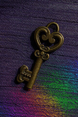 Vintage key. .Antique key. Retro key on  on colorful fabric