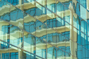 Large mirrored green windows with distorted reflection