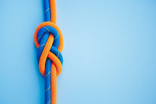 Eight knot on a rope on a blue background close up