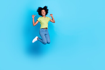 Fototapeta na wymiar Full body photo of little positive girlish teenager nice chevelure jumping trampoline fingers point herself best one empty space ad isolated on blue color background