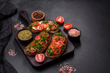 Tasty bruschetta with tomatoes, mozzarella, basil, spices and herbs