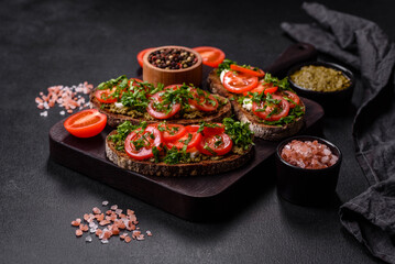 Tasty bruschetta with tomatoes, mozzarella, basil, spices and herbs
