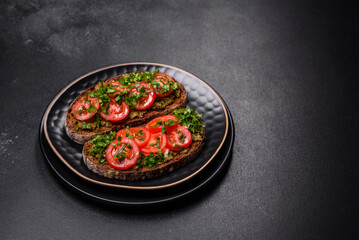 Tasty bruschetta with tomatoes, mozzarella, basil, spices and herbs