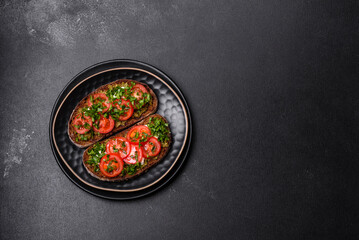 Tasty bruschetta with tomatoes, mozzarella, basil, spices and herbs