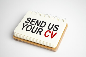 send us your cv Text on business paper on office table