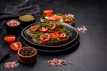 Tasty bruschetta with tomatoes, mozzarella, basil, spices and herbs