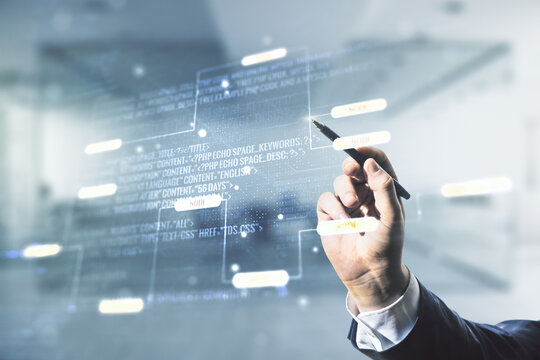Multi exposure of businessman hand with pen working with abstract graphic coding sketch on blurred office background, big data and networking concept
