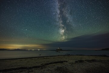 Milky Way and night sky over St Cwyfans Church at Anglesey, Wales
