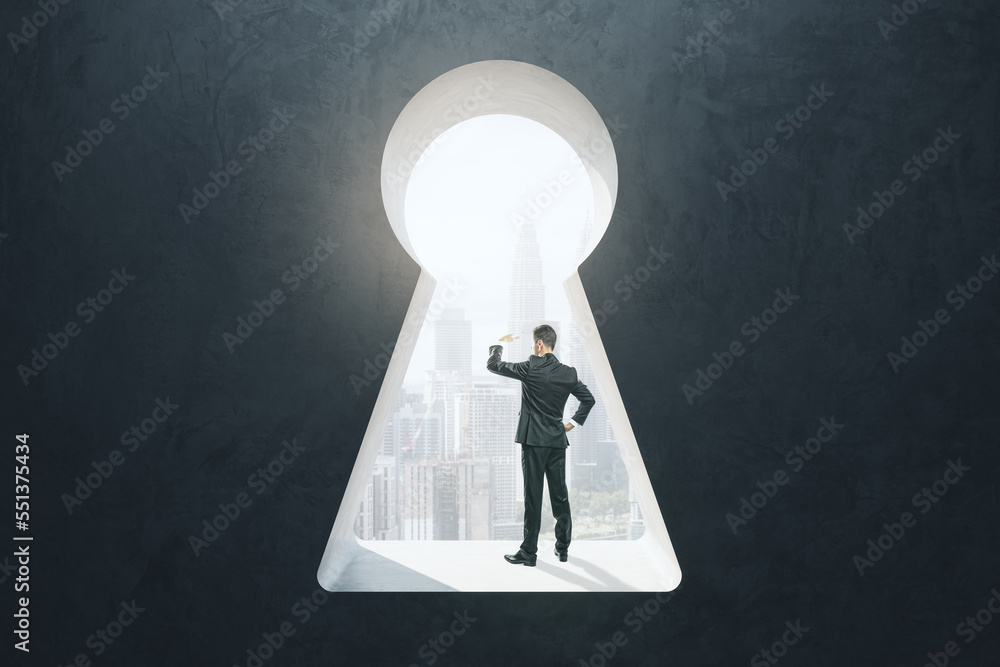 Aufkleber abstract image of businessman standing in keyhole opening and looking into the distance on blurry ci
