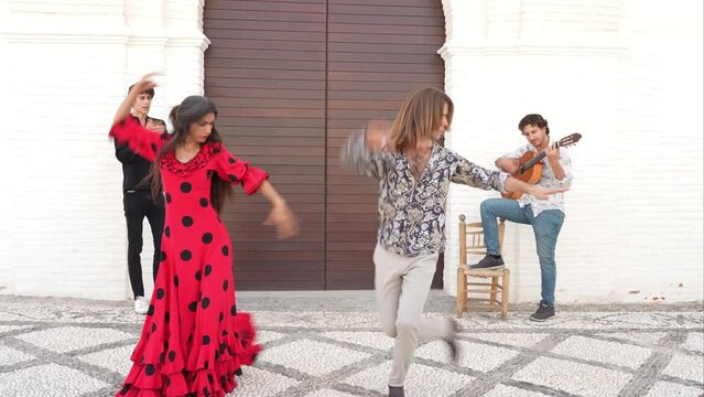 Multiethnic group of flamenco dancers dancing for tourists in San Nicolas. Albaicin.