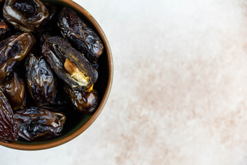 Dates fruit in bowl on white background. Dried organic Superfood.