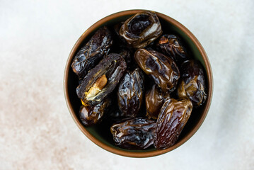 Dates fruit in bowl on white background. Dried organic Superfood.