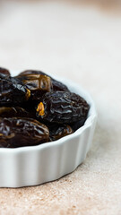 Dates fruit in bowl on white background. Dried organic Superfood.