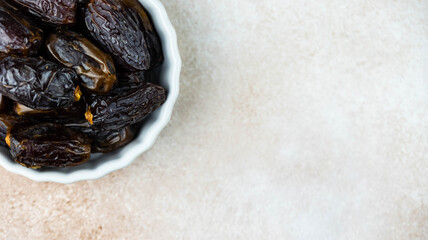 Dates fruit in bowl on white background. Dried organic Superfood.