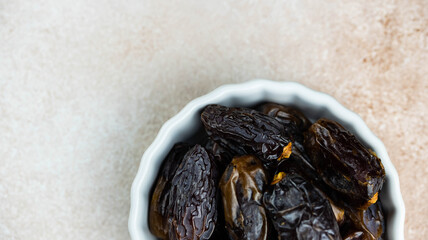 Dates fruit in bowl on white background. Dried organic Superfood.