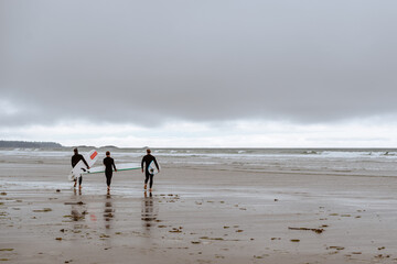 Three surfers on the beach