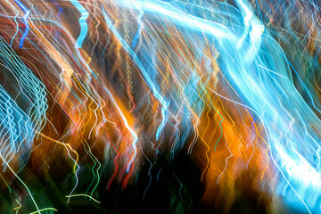 Abstract blurred bokeh neon light trails city night background