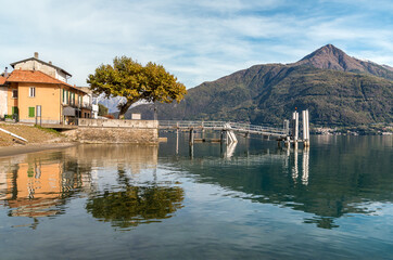 Obraz premium Landscape of Lake Como with the pier of the Cremia village at autumn time, Lombardy, Italy
