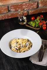 Italian Pasta Bolognese on a white plate with ingredients on a dark background. restaurant menu