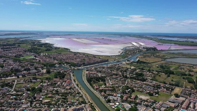 Large aerial view over saltworks with pink ponds and marshes canal du Rhone a Sete 