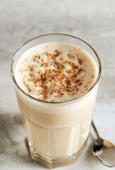 coffee with milk and grated nut in a glass close-up. Raff coffee