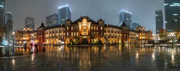Fototapeta na wymiar Japan architecture. Tokyo attractions. Building of railway station. Excursions to cities of Japan. Tokyo in rainy weather. Japanese city in autumn evening. Tokyo architecture. Tour of Japan