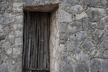 Fototapeta na wymiar old door in intricate stone wall