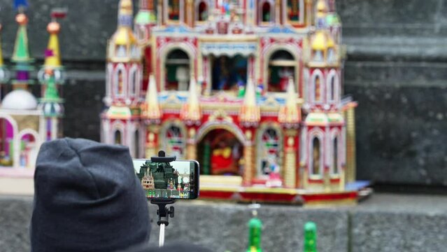 Tourist shoots on smartphones annual creative competition of miniature models of attractions of Krakow on the eve of Christmas, a traditional exhibition of hand works in the center of Krakow