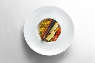 grilled salmon with saffron rice on a large white plate
