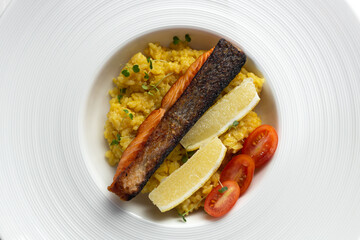 grilled salmon with saffron rice on a large white plate