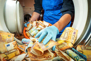 Euro money banknotes in a washing machine, closeup inside view. Concept of corruption, money...