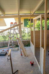 Moving to a new house. Outdoor patio pergola shade structure, patio roof and wooden gazebo under construction, garden lounge