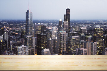 Empty wooden tabletop with beautiful Chicago skyscrapers at night on background, mock up