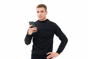 a man in black with a smartphone in his hands on a white background.