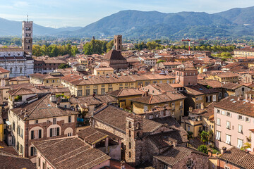 Fototapeta premium Lucca, Italy. Aerial view of a medieval town with church bell towers and tiled roofs
